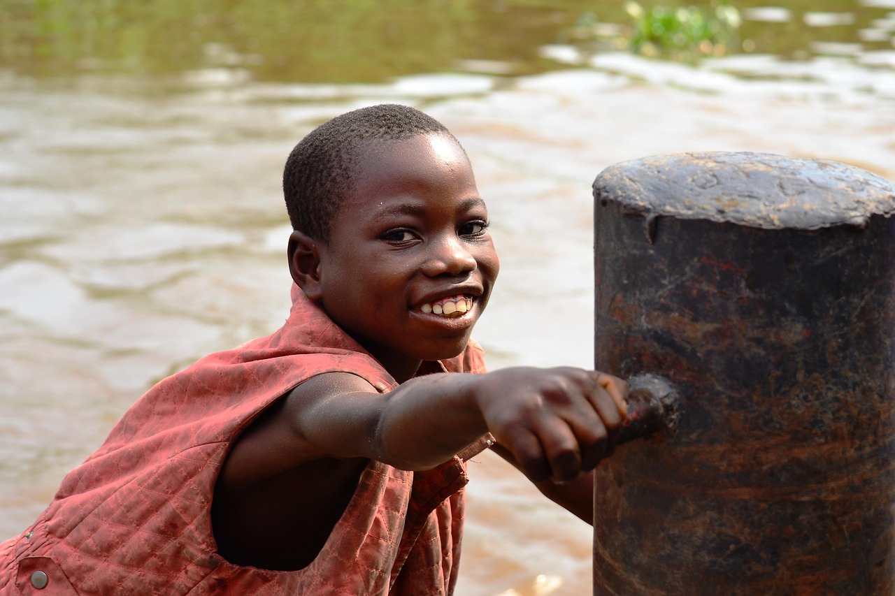 A boy getting water by Congo River in DRC - via PixaBay