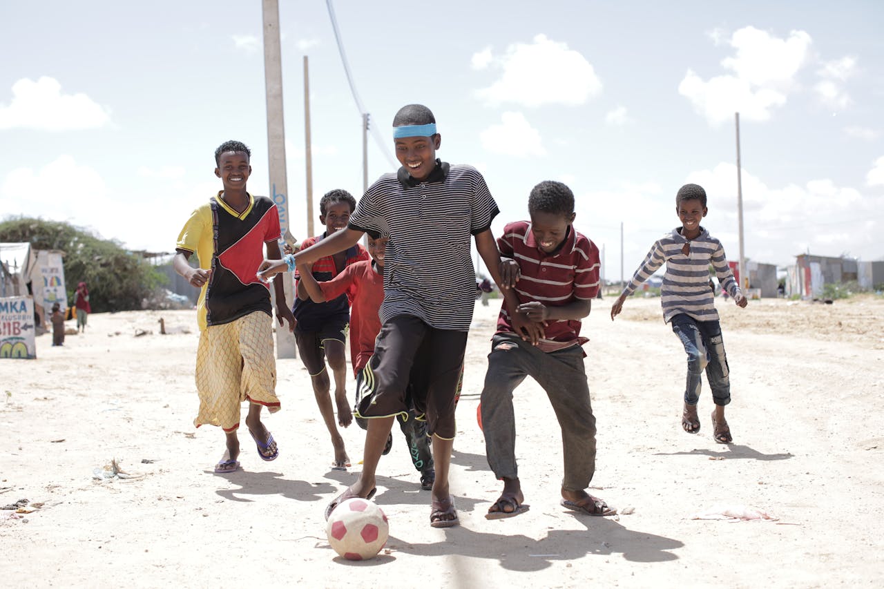 Friends playing football in Somalia - via PixaBay