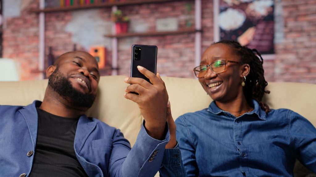 African friends looking at smartphone